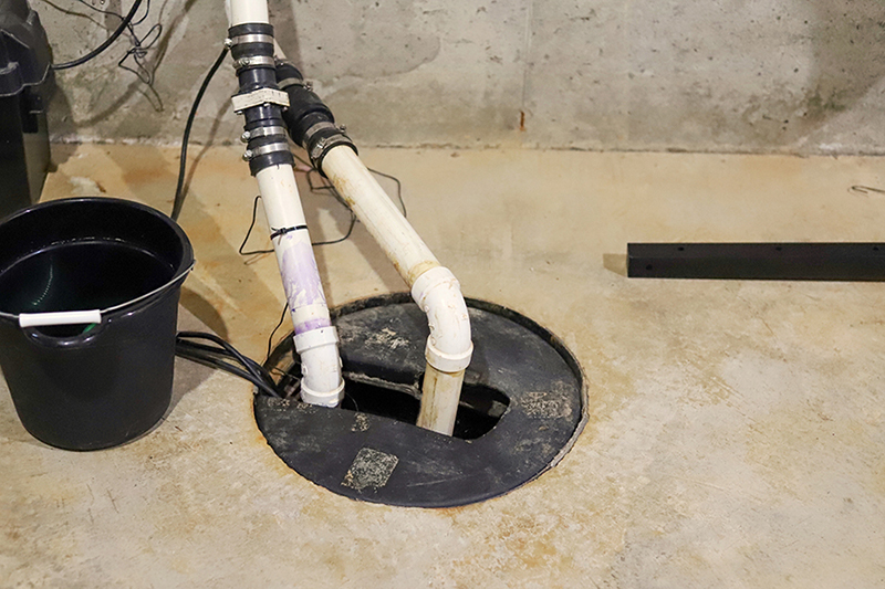 2025 Sump Pump Buying Guide. Photo of a sump pump in a basement.
