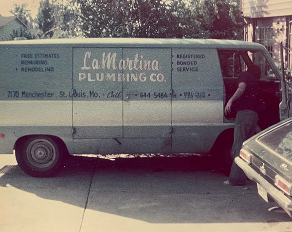 Vintage LaMartina Plumbing Co. truck with a young Tony LaMartina at the front passenger door.